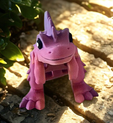 Pink plush toy with a dragon-like design on a natural background